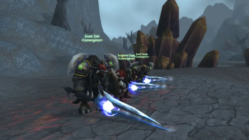Two guild characters holding glowing swords in a rocky landscape.
