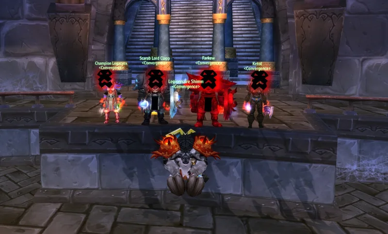 A guild group posing on stone steps above a defeated enemy.