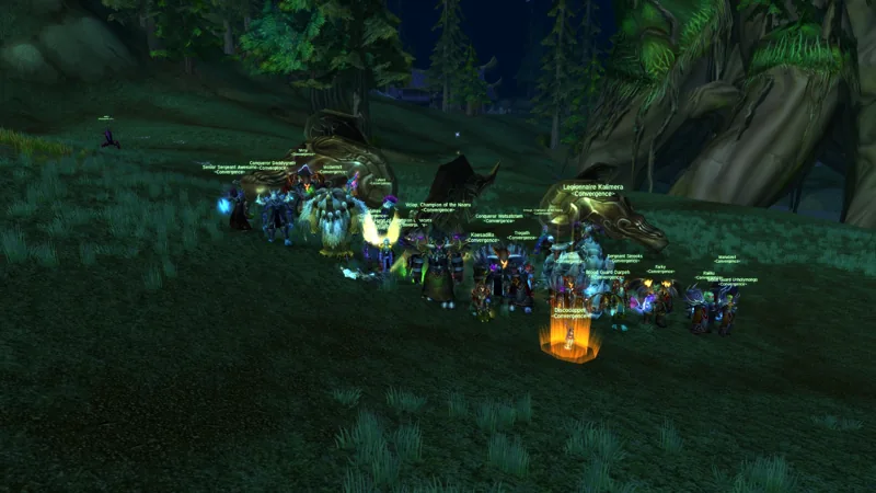 Convergence raiders gathered together on a forested hillside beside a fallen enemy.
